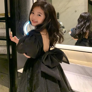 Vestido de tul negro para niñas con mangas abullonadas y lazo grande en la espalda