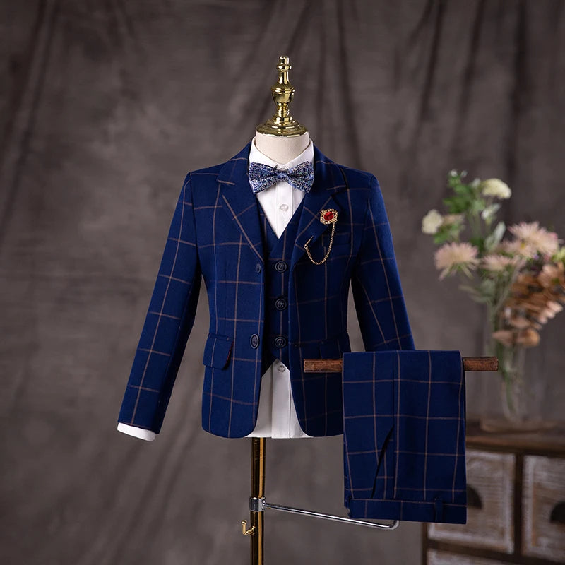 Conjunto de traje formal para niño con blazer a cuadros azul marino, chaleco y pantalón, pajarita y prendedor de solapa. 