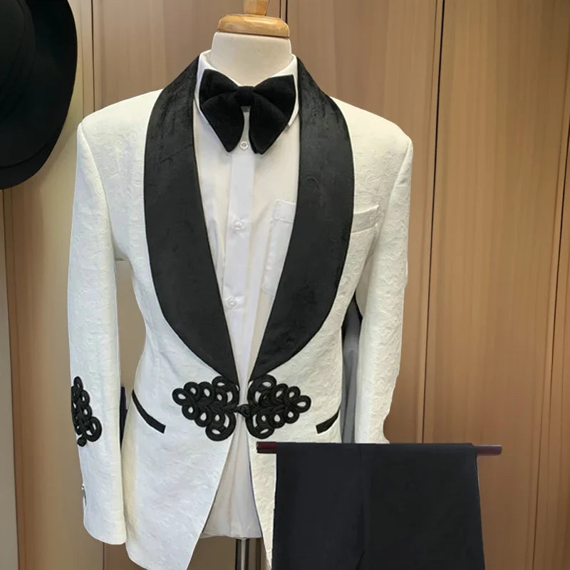 Veste blanche pour homme avec revers châle noir et détails brodés. Pantalon assorti inclus. 