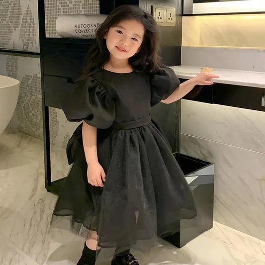 Vestido de tul negro para niñas con mangas abullonadas y lazo grande en la espalda