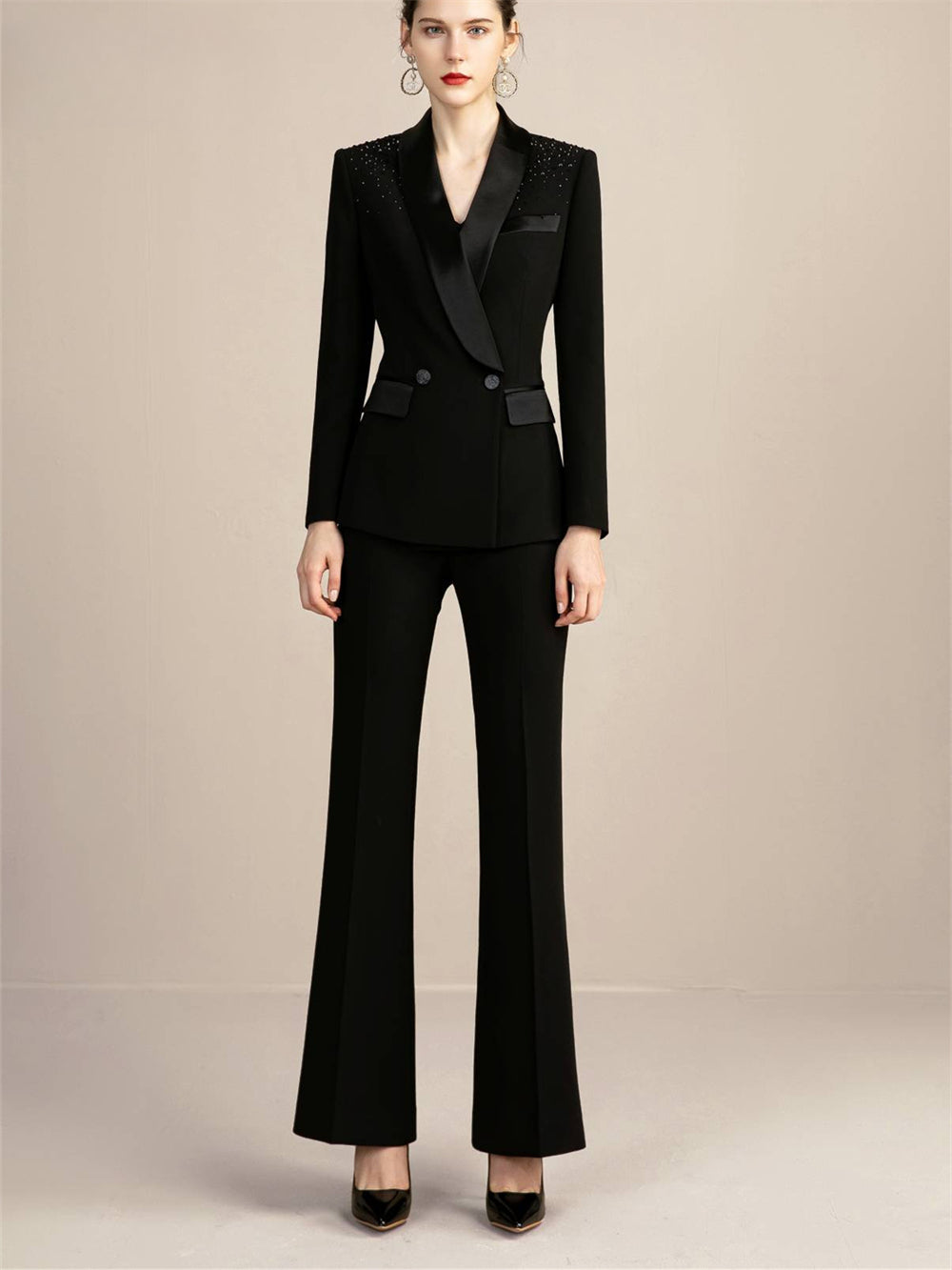 Elegante traje negro cruzado para mujer con detalles brillantes, pantalón de dos piezas con cuello sedoso y manga larga para un estilo chic otoñal.